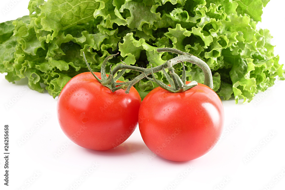 Two tomatos and salad isolated on white Two tomatos and salad isolated on white
