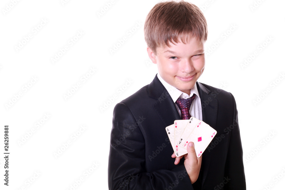 Young boy in a suit secretly showing his cards Young boy in a suit secretly showing his cards