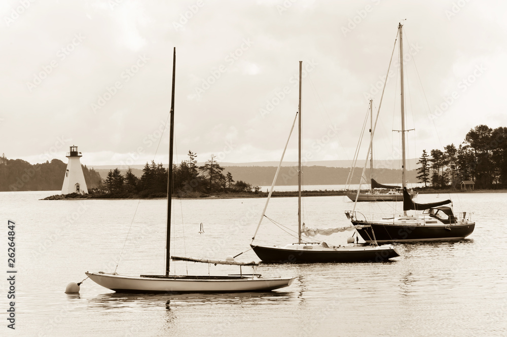 Boats and lighthouse on Bras D'Or lake, Cape Breton, Nova Scotia