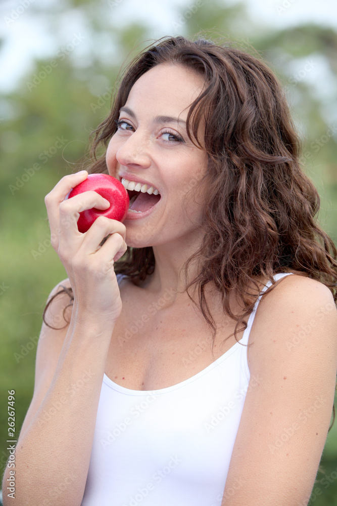 Closeup of woman eating a red apple Closeup of woman eating a red apple