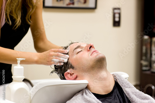 Attractive man having a shampoo