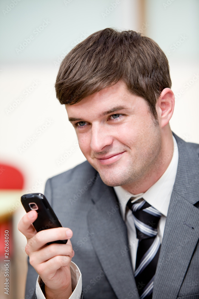 Portrait of an assertive businessman sending a text message with Portrait of an assertive businessman sending a text message with