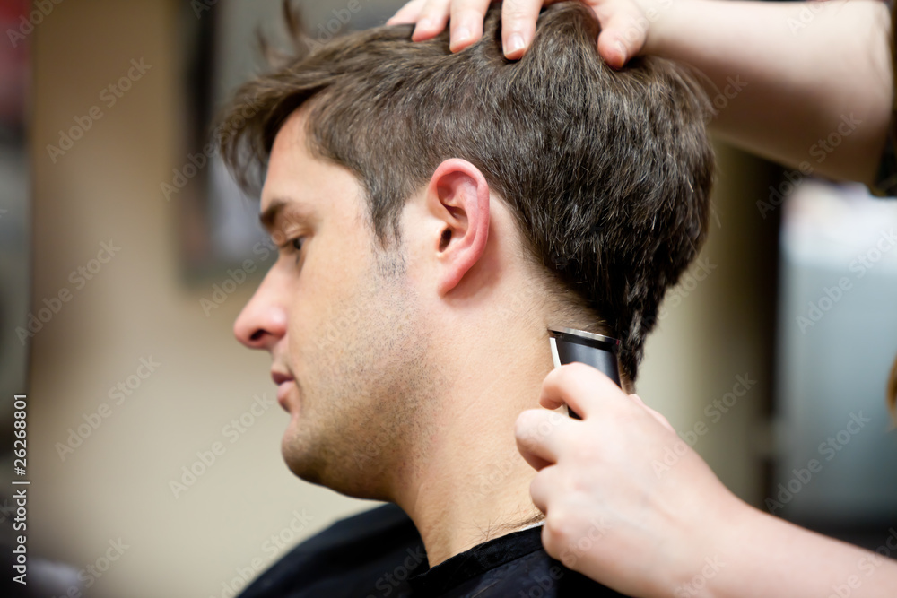 Hairdresser cutting her customer's hair in barbershop Hairdresser cutting her customer's hair in barbershop