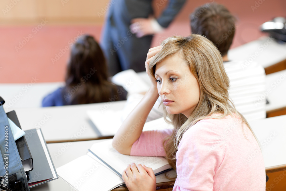 Portrait of a bored female student during a university lesson Portrait of a bored female student during a university lesson