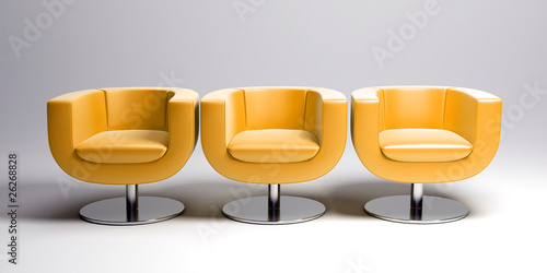 Three yellow leather armchairs