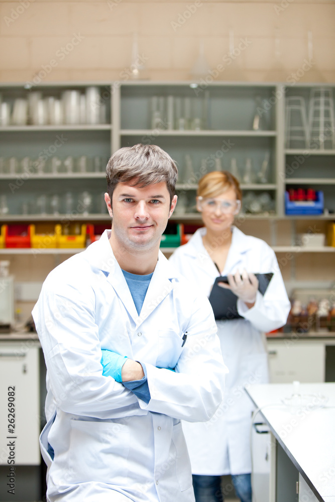 Fototapeta premium Two serious scientists looking at the camera standing