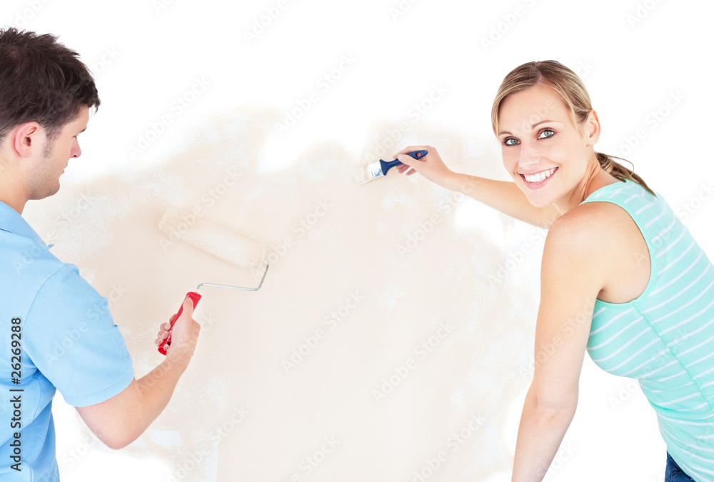 Smiling couple painting a room