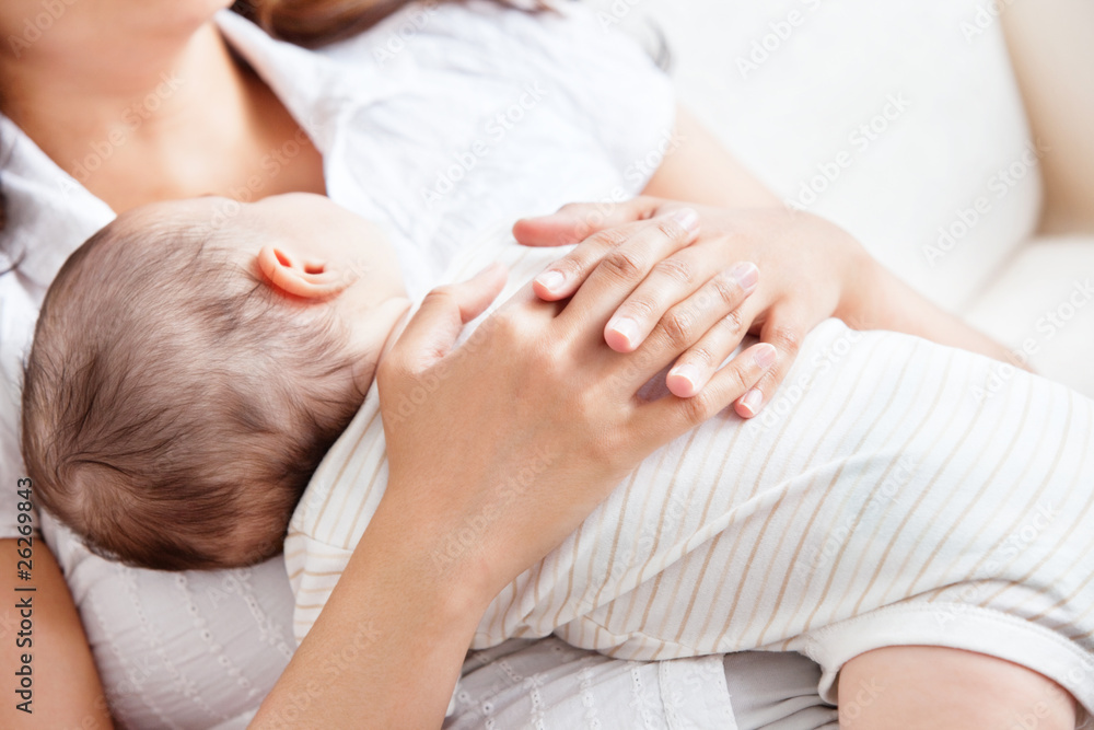 Delighted young mother taking care of her adorable baby Delighted young mother taking care of her adorable baby