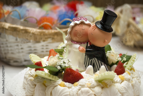 Comical bride and groom figurines on top of wedding cake