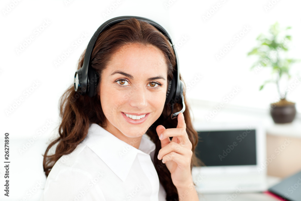 Pretty hispanic businesswoman with headset sitting at her desk Pretty hispanic businesswoman with headset sitting at her desk