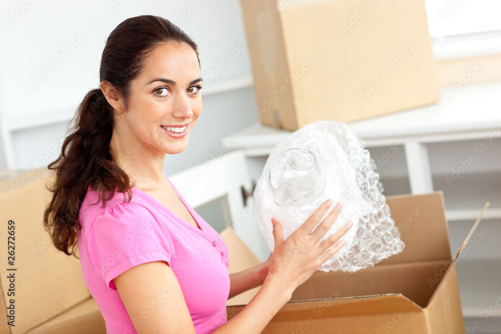 Beautiful hispanic woman unpacking boxes of glasses Beautiful hispanic woman unpacking boxes of glasses