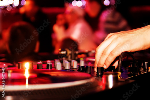 DJ playing vinyl on turntable photo