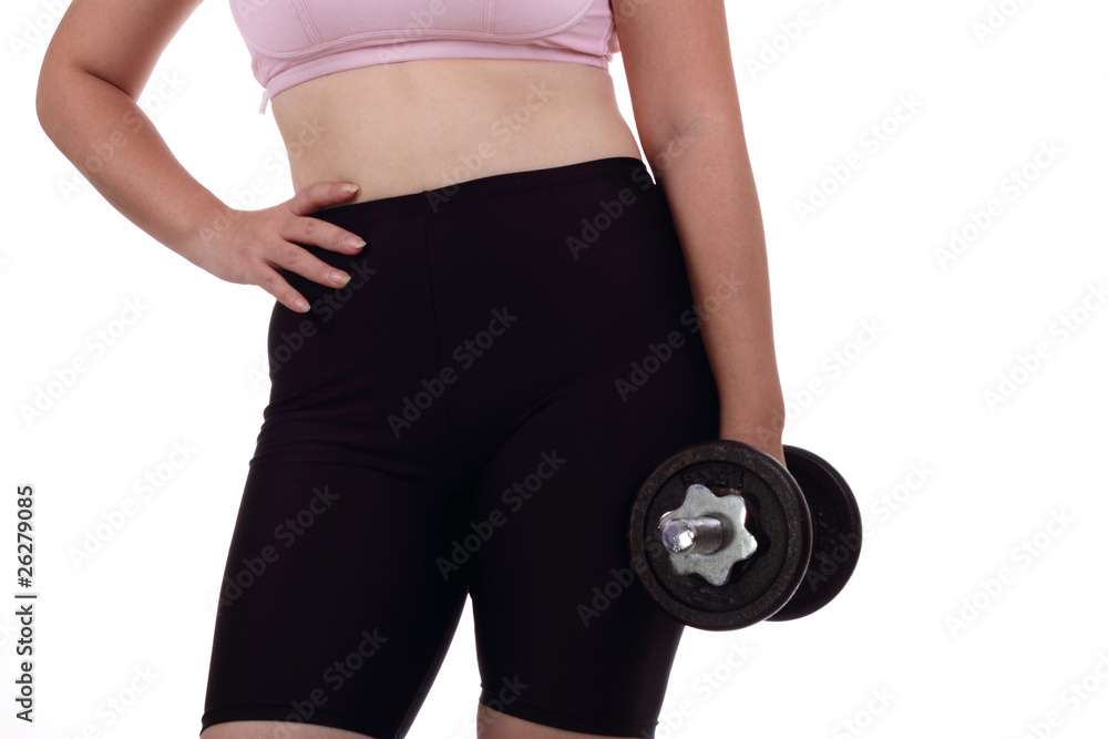 Woman standing holding a dumbbell Woman standing holding a dumbbell
