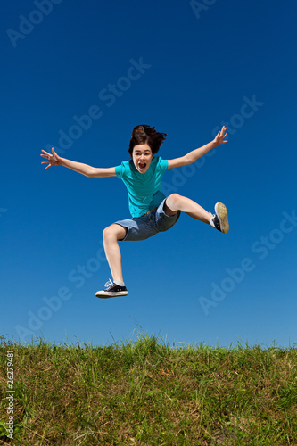 Girl jumping  running against blue sky