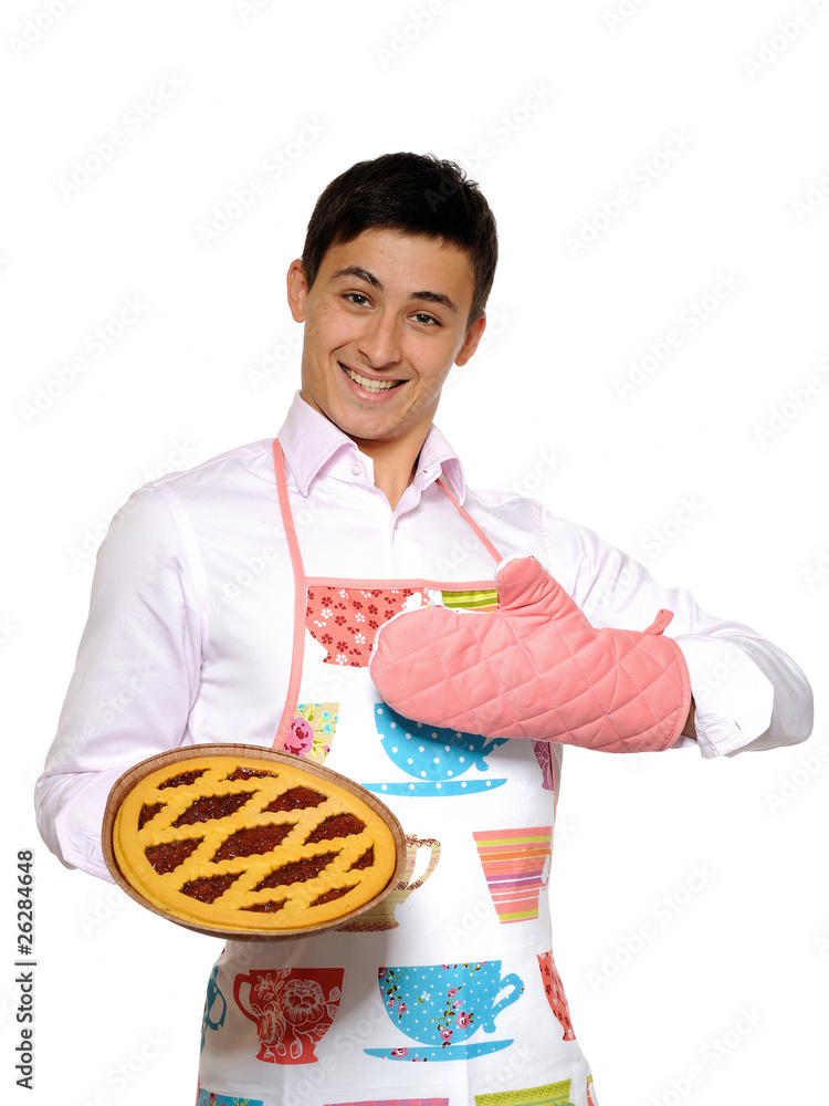 Cooking. Young man in apron baked tasty pie. isolated on white b