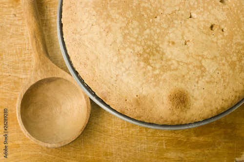 fresh pie and spoon on a wooden cutting board