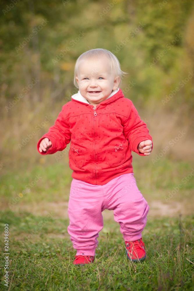 young adorable baby walking by the road in field near forest young adorable baby walking by the road in field near forest