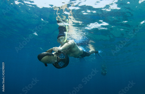 Fototapeta Naklejka Na Ścianę i Meble -  snorkeler on underwater scooter