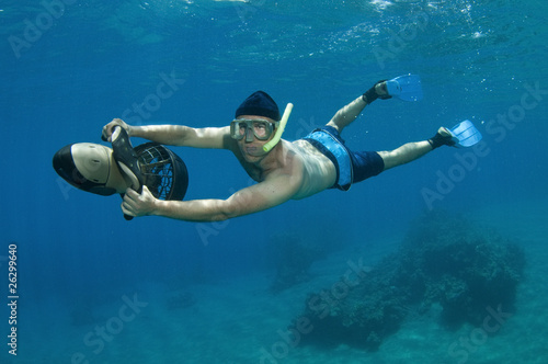 snorkeler on underwater scooter