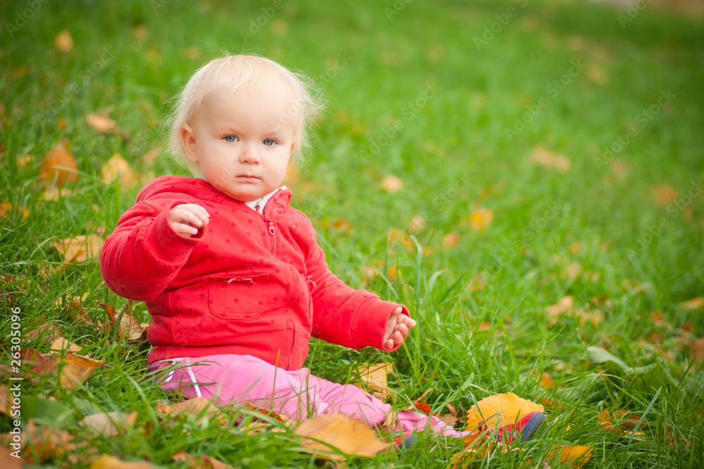 young adorable cheerful baby sit in park on green grass play wit young adorable cheerful baby sit in park on green grass play wit