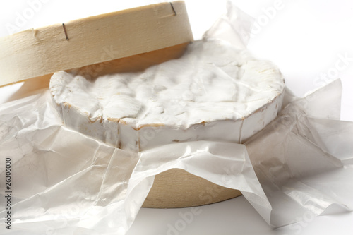 Whole Camembert cheese in a wooden box