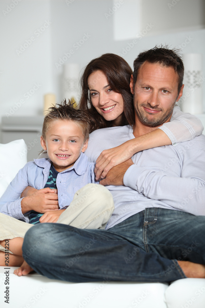Closeup of parents and child relaxing at home on sofa Closeup of parents and child relaxing at home on sofa