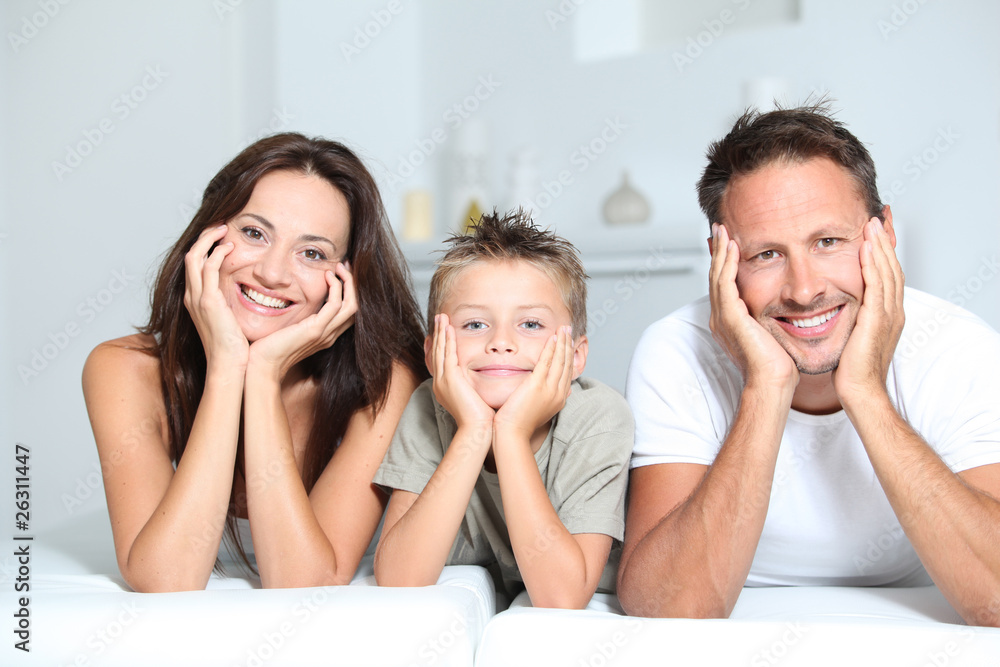Closeup of parents and child relaxing at home on sofa Closeup of parents and child relaxing at home on sofa