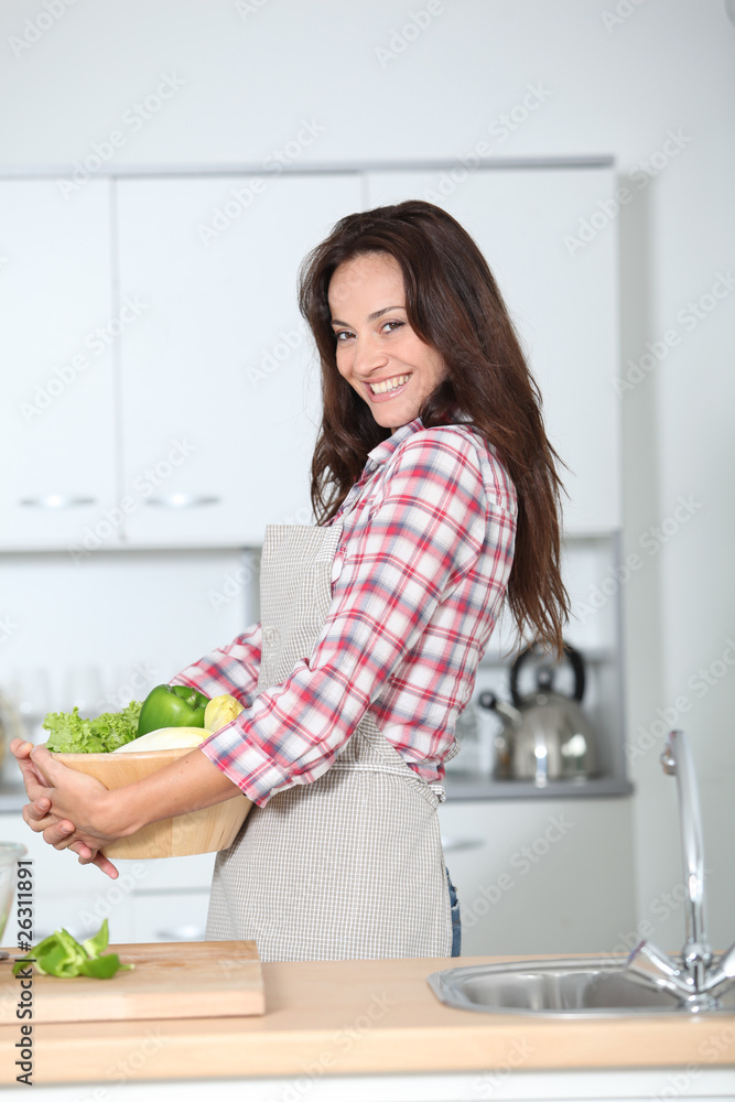 Beautiful woman stading in kitchen with apron Beautiful woman stading in kitchen with apron