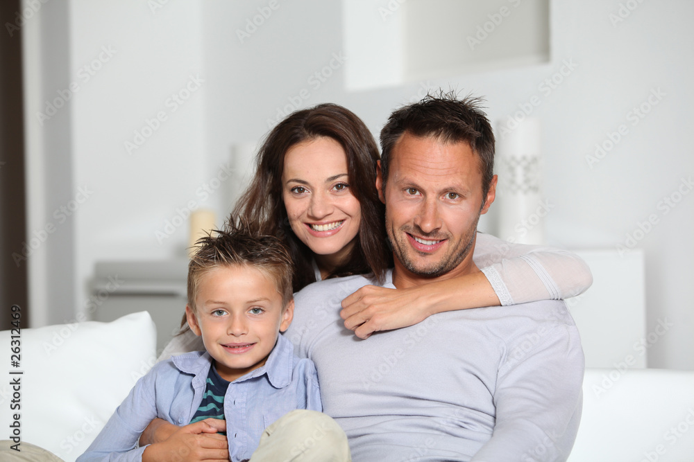 Closeup of parents and child relaxing at home on sofa Closeup of parents and child relaxing at home on sofa