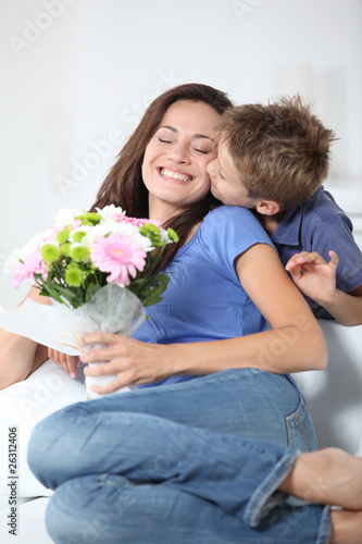 Little boy kissing his mom on mother's day