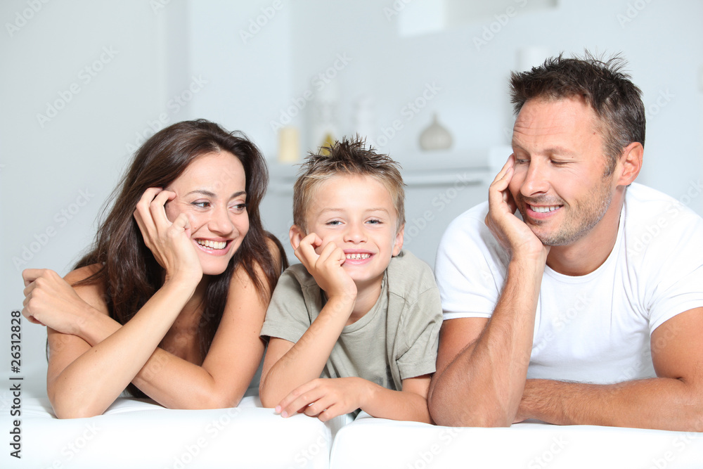 Closeup of parents and child relaxing at home on sofa Closeup of parents and child relaxing at home on sofa