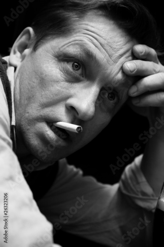 A solitary man sits at a bar