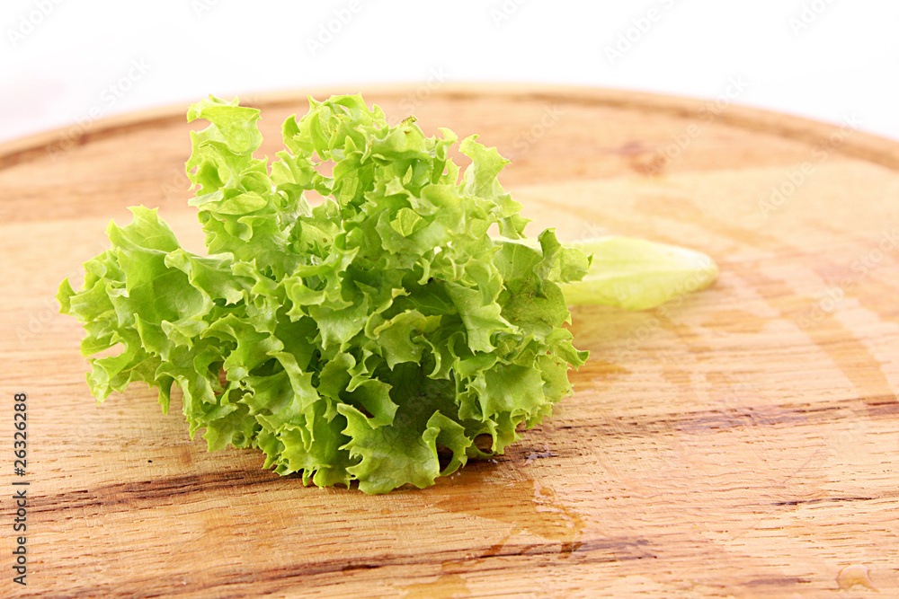 Green salad leaves on wooden surface Green salad leaves on wooden surface
