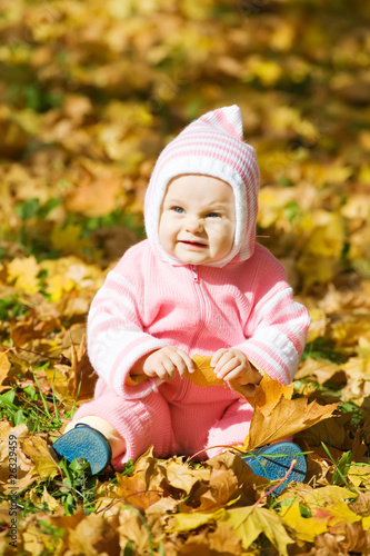 Kid  in autumn leaves