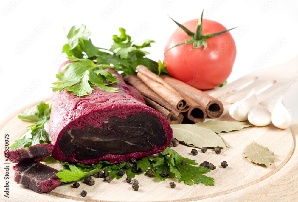 dried meat with spices and vegetables on board dried meat with spices and vegetables on board