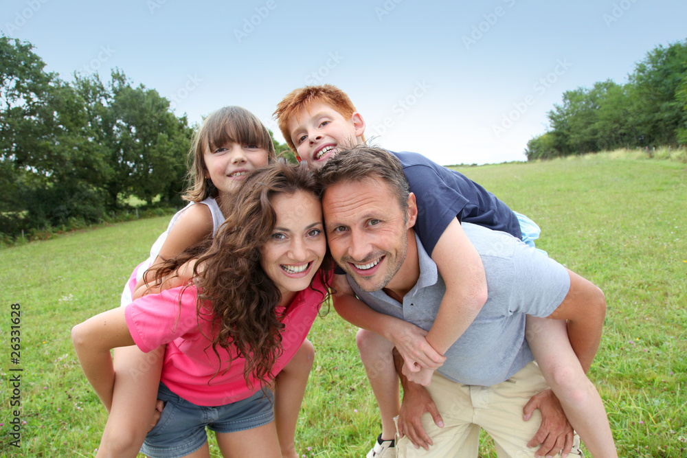 Parents doing piggyback to their children Parents doing piggyback to their children