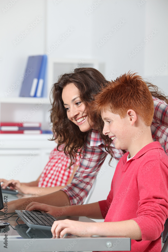 Teacher and children learning to use computer Teacher and children learning to use computer