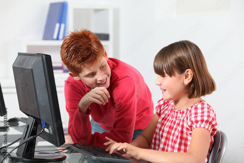 Children sitting in classroom in front of computer Children sitting in classroom in front of computer