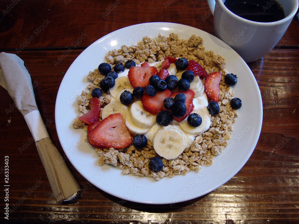 Granola, Fruit and Yogurt with a bowl with a cup of coffee and
