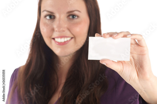 Smiling young woman with blank card (focus on hand) (isolated)