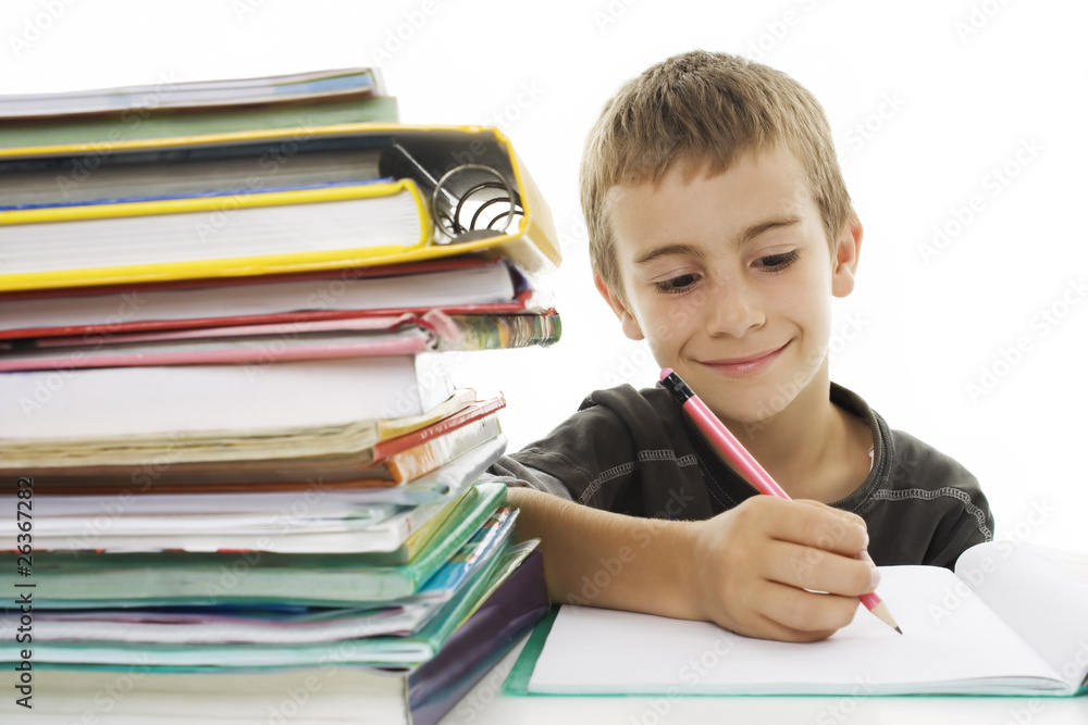 School boy sitting and writing in notebook. School boy sitting and writing in notebook.