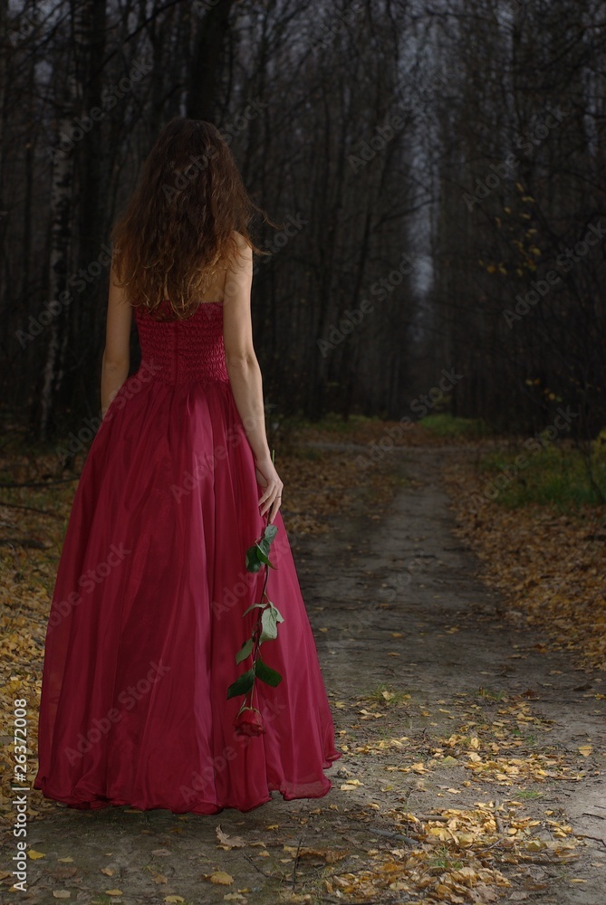 Fototapeta premium Female walking in the autumn forest
