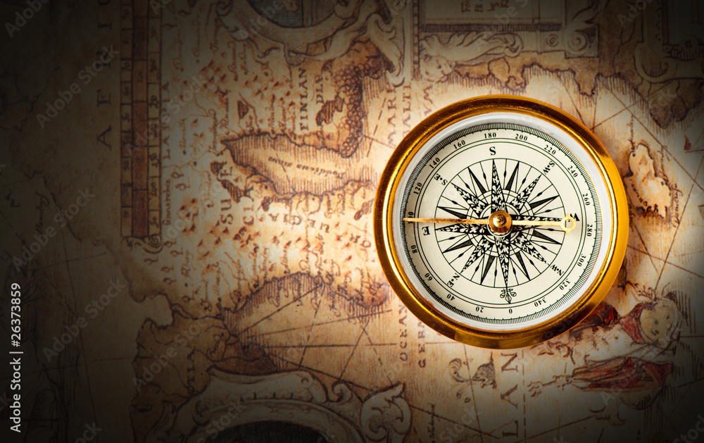 Old compass on ancient map