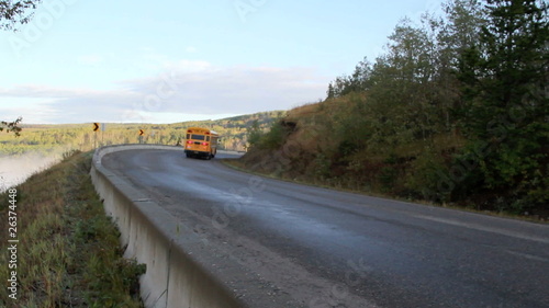school bus climbing hill and going around a corner