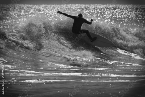 Surfer on a wave in black and white