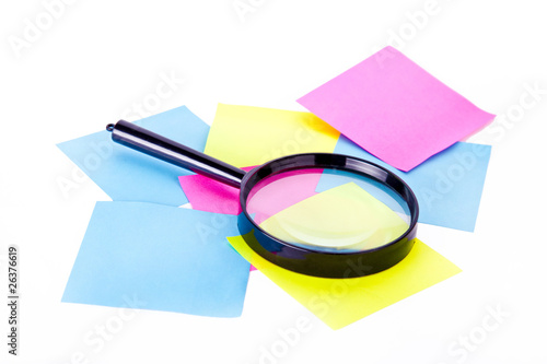 Notes and loupe isolated at white background.