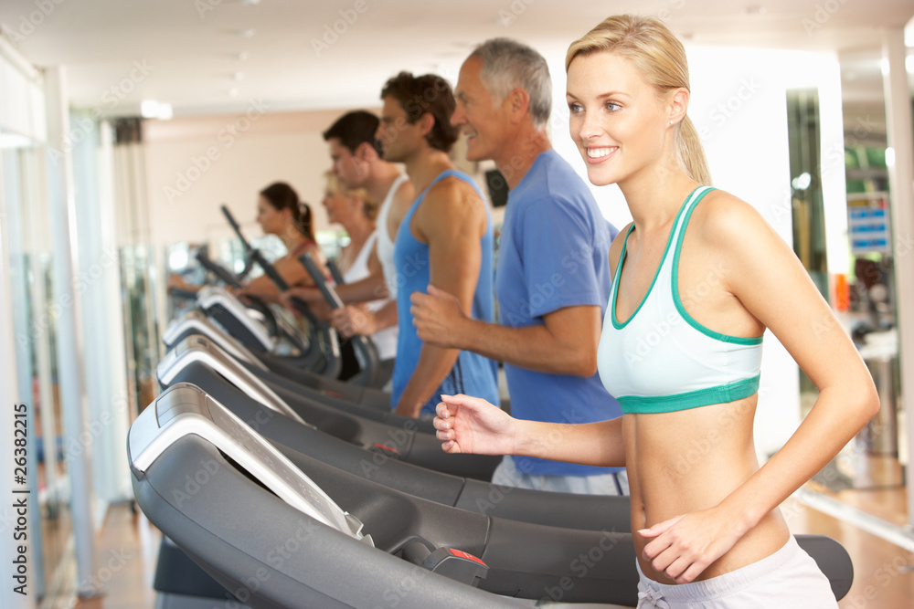 Woman On Running Machine In Gym