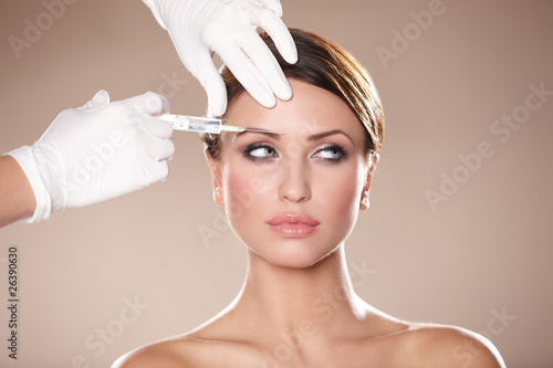 Beautiful woman receives injection in her face photo