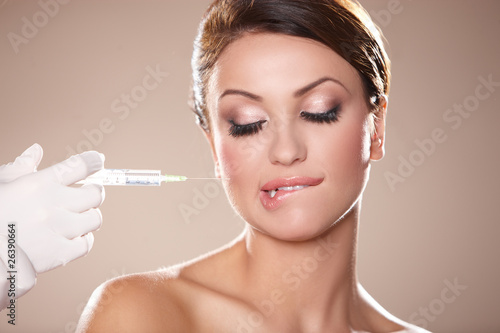 Young woman about to receive cosmetic injection with syringe