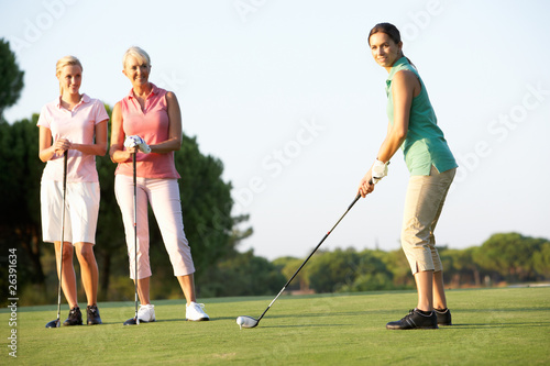 Group Of Female Golfers Teeing Off On Golf Course